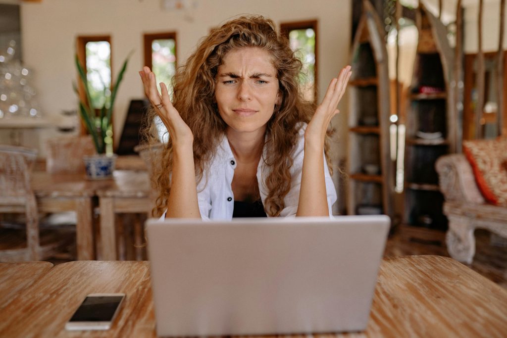 Supplier looking frustrated at laptop.